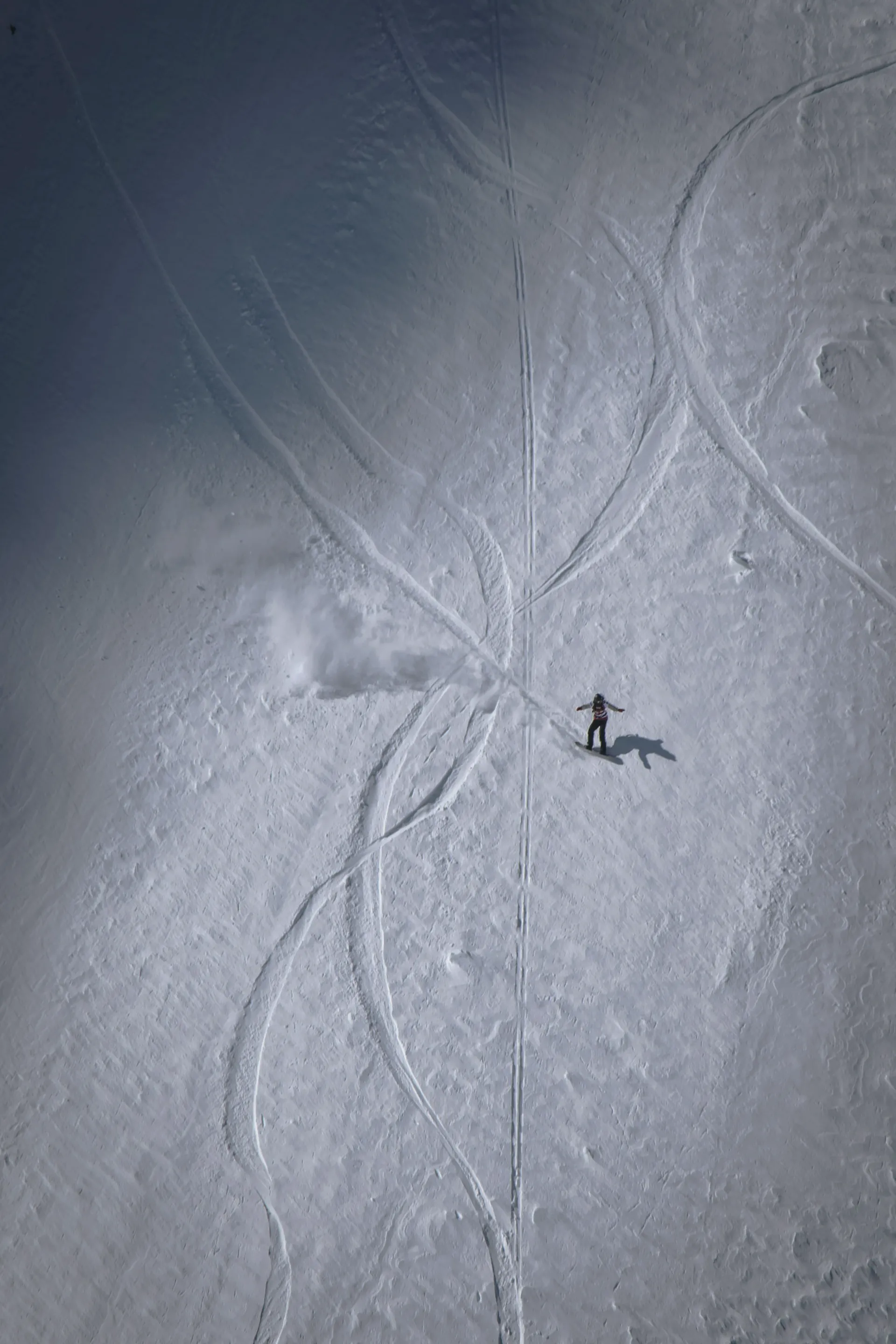 Jody Smithが真っ白な雪の斜面をスノーボードで滑り降りる写真